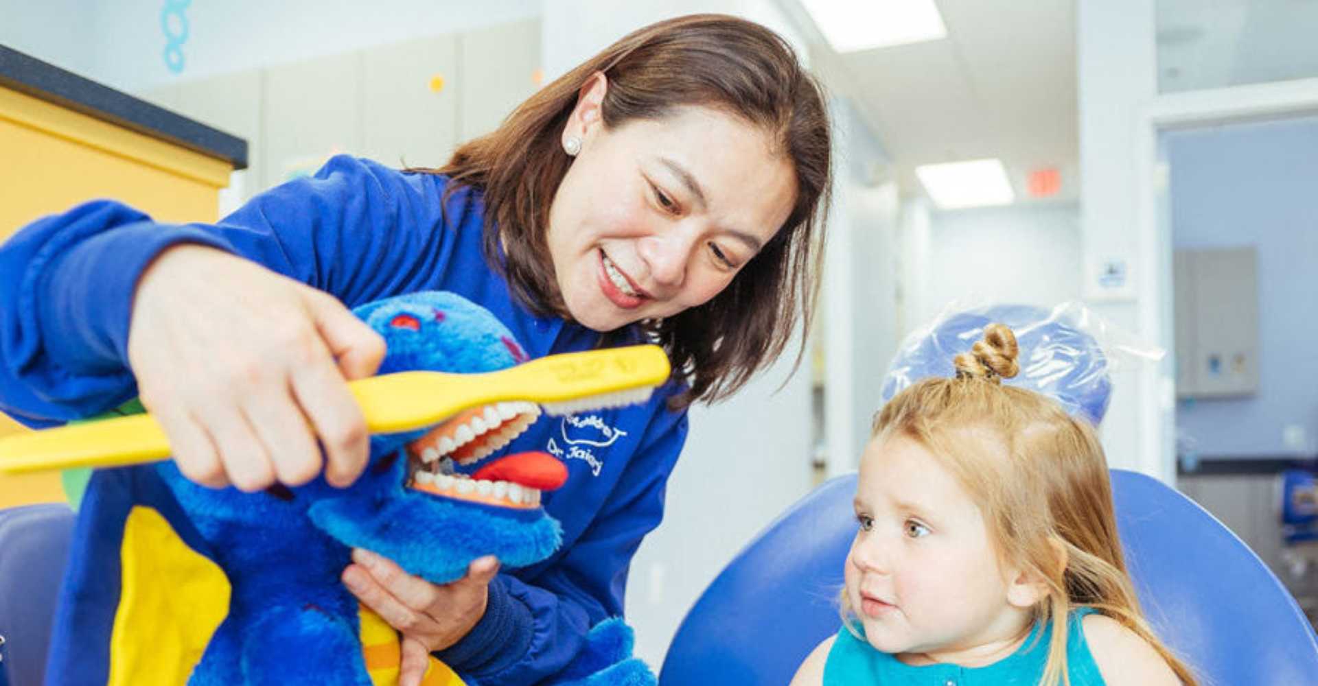 Dentist teaching the kid on oral hygine